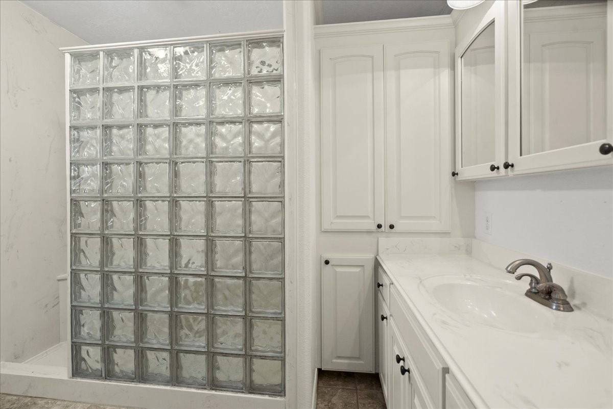 105 Alice Street Anahuac, TX 77514 - Photo 16 of 36 a bathroom with a sink and a tub