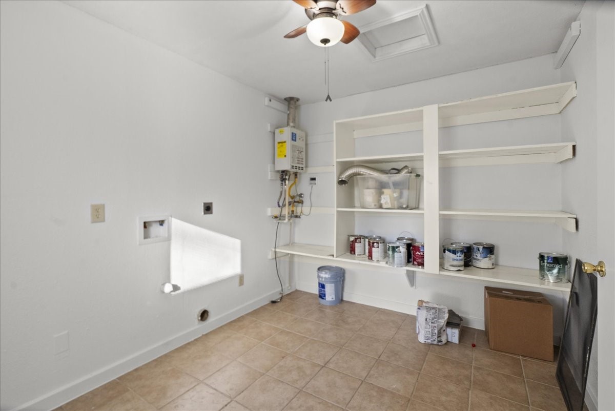 105 Alice Street Anahuac, TX 77514 - Photo 17 of 36 a room with a cabinets and a window