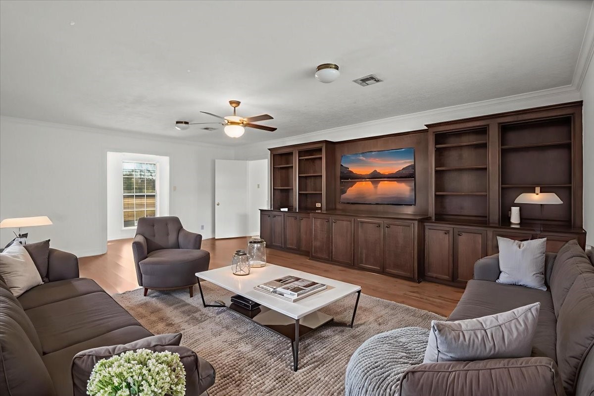 105 Alice Street Anahuac, TX 77514 - Photo 25 of 36 a living room with furniture and a flat screen tv