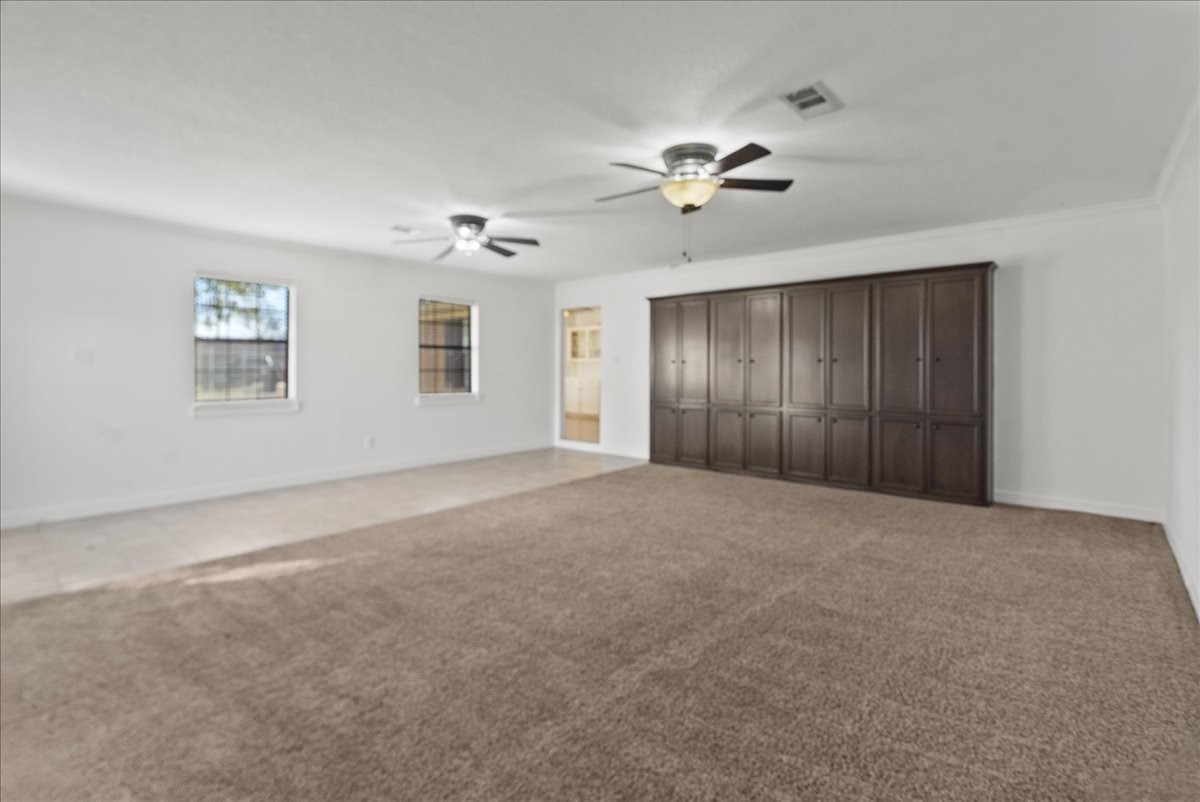 105 Alice Street Anahuac, TX 77514 - Photo 26 of 36 a view of an empty room with a ceiling fan