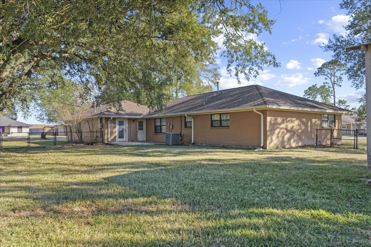 105 Alice Street Anahuac, TX 77514 - Photo 36 of 36 a front view of a house with a garden