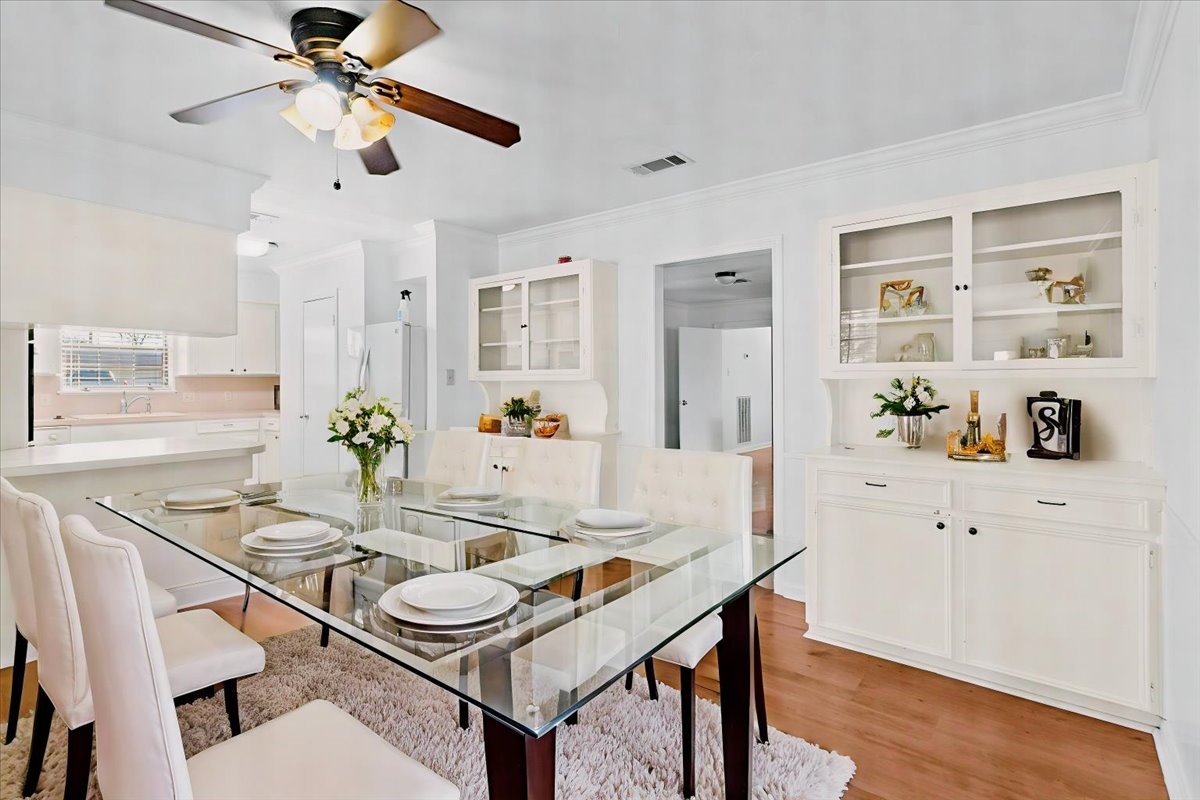 105 Alice Street Anahuac, TX 77514 - Photo 5 of 36 a view of a dining room with furniture and wooden floor