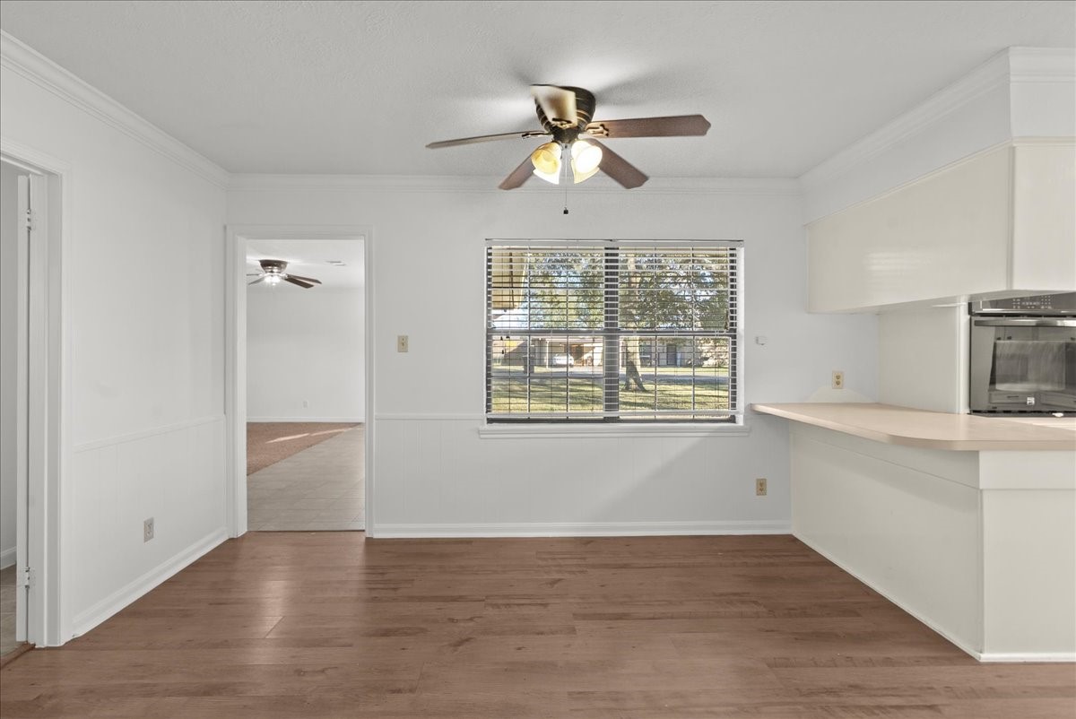 105 Alice Street Anahuac, TX 77514 - Photo 6 of 36 a view of an empty room with a window and wooden floor