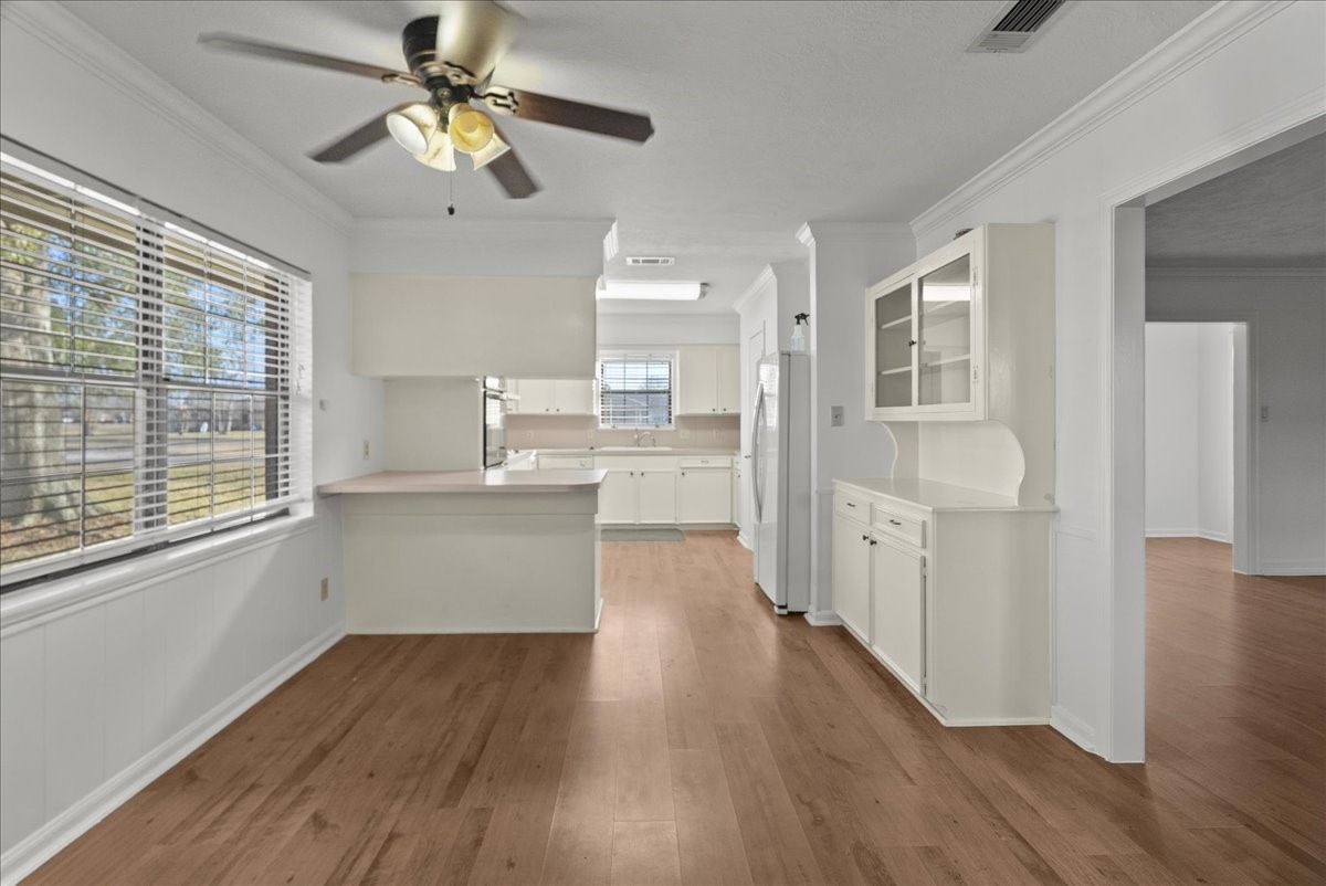 105 Alice Street Anahuac, TX 77514 - Photo 10 of 36 a view of a kitchen with wooden floor and a window