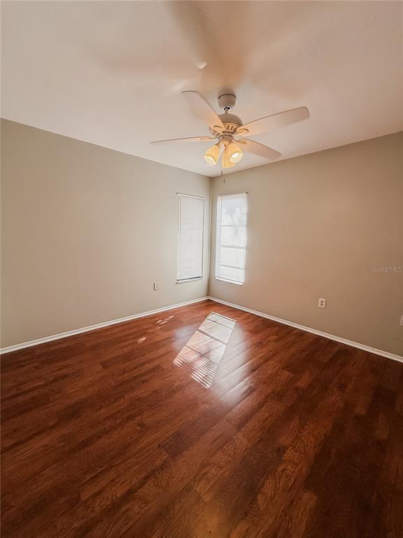 5364 Deltona Boulevard Spring Hill, FL 34606 - Photo 13 of 36 an empty room with wooden floor and windows