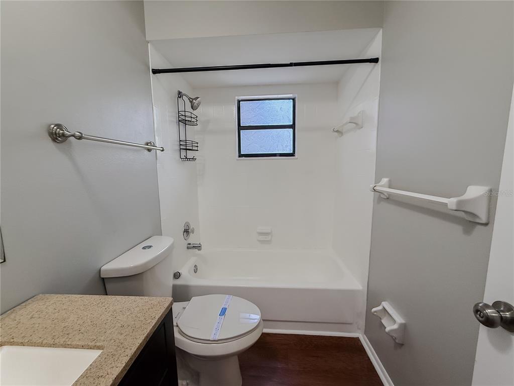 5364 Deltona Boulevard Spring Hill, FL 34606 - Photo 15 of 36 a bathroom with a sink and toilet