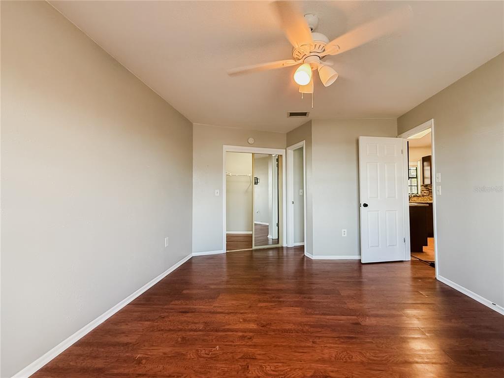 5364 Deltona Boulevard Spring Hill, FL 34606 - Photo 19 of 36 a view of an empty room with wooden floor