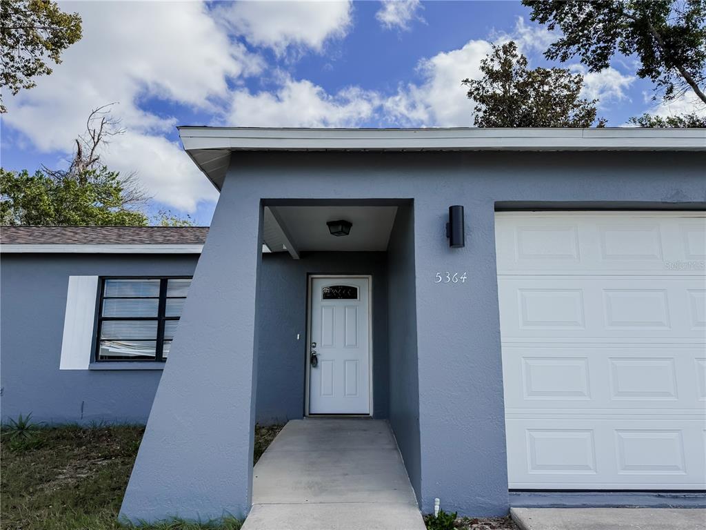5364 Deltona Boulevard Spring Hill, FL 34606 - Photo 2 of 36 a front view of a house with a door