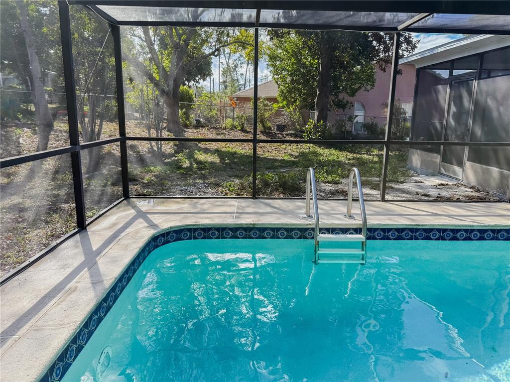 5364 Deltona Boulevard Spring Hill, FL 34606 - Photo 27 of 36 a view of a swimming pool with a porch