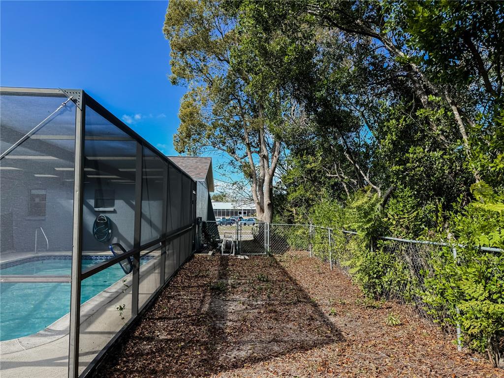 5364 Deltona Boulevard Spring Hill, FL 34606 - Photo 30 of 36 a backyard of a house with lots of green space