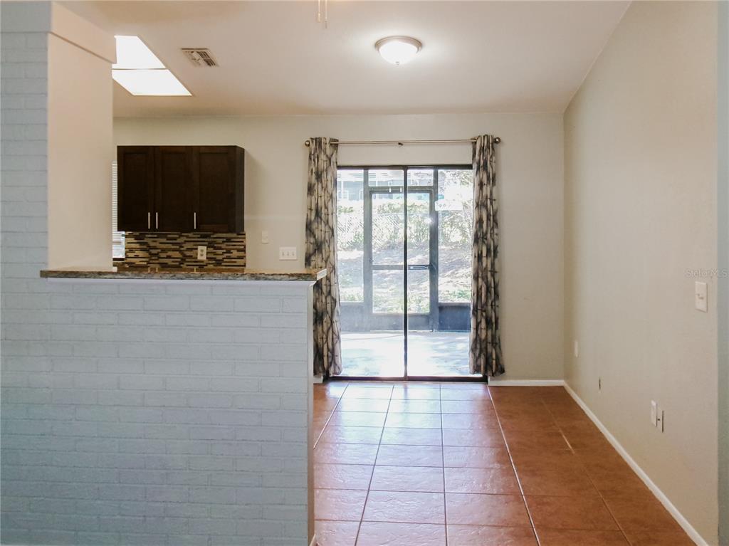 5364 Deltona Boulevard Spring Hill, FL 34606 - Photo 6 of 36 a view of hallway with furniture and a flat screen tv