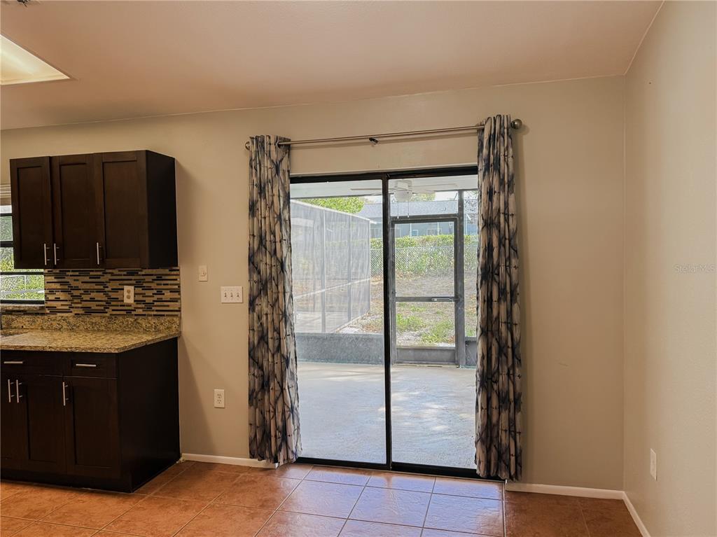 5364 Deltona Boulevard Spring Hill, FL 34606 - Photo 7 of 36 a kitchen with stainless steel appliances granite countertop a refrigerator and a stove