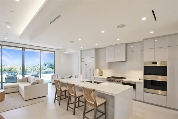 a kitchen with a sink and a stove top oven with wooden floor