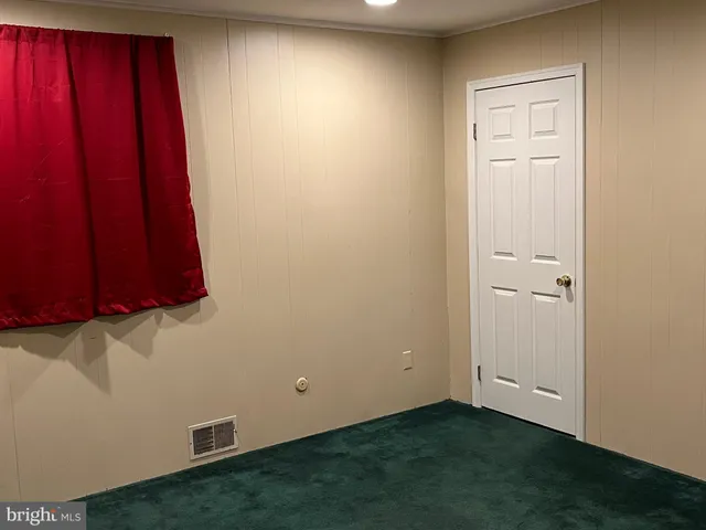an empty room with a window and a door