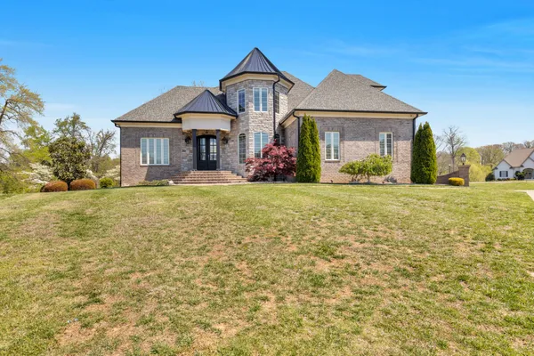a front view of a house with a yard