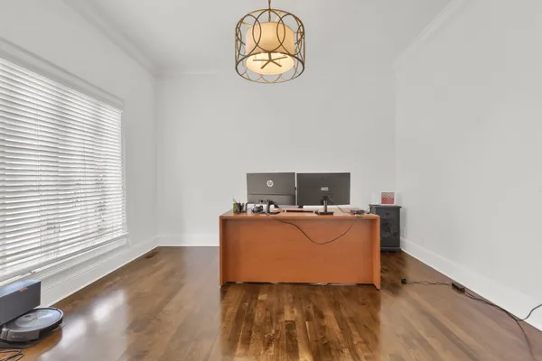 a spacious bedroom with a bed and a chandelier