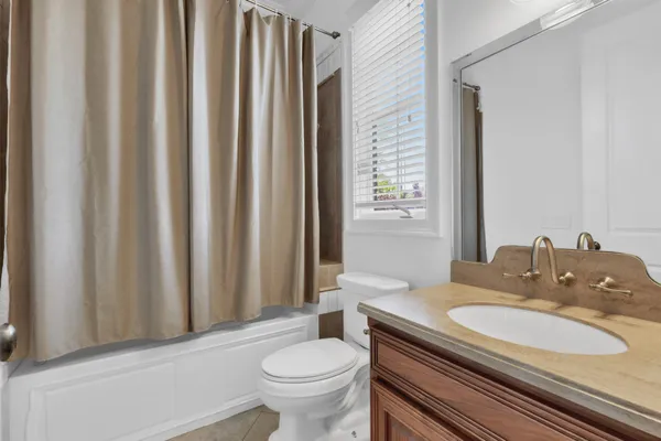 a bathroom with a bathtub and window