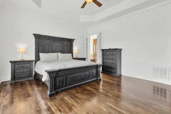 a bedroom with a bed and a chandelier