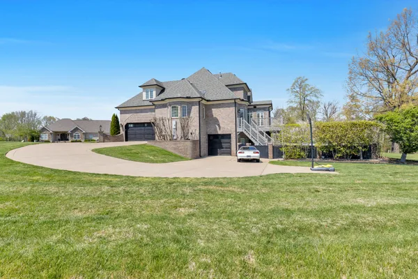 an aerial view of a house with a big yard