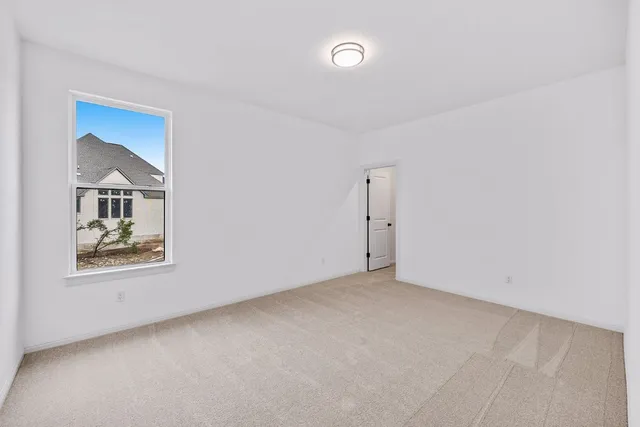 an empty room with windows and cabinet