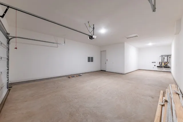 a kitchen with white cabinets and sink