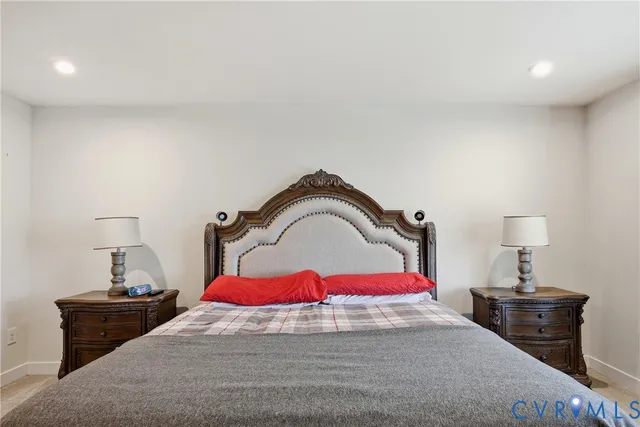 a bedroom with a bed and a lamp