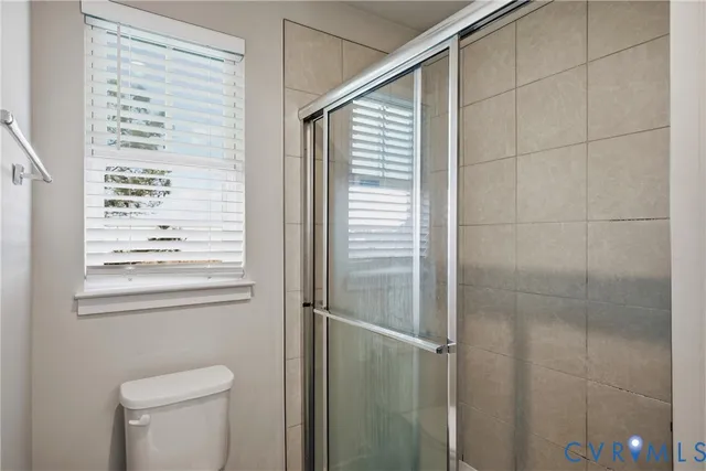 a bathroom with a toilet a sink and a shower