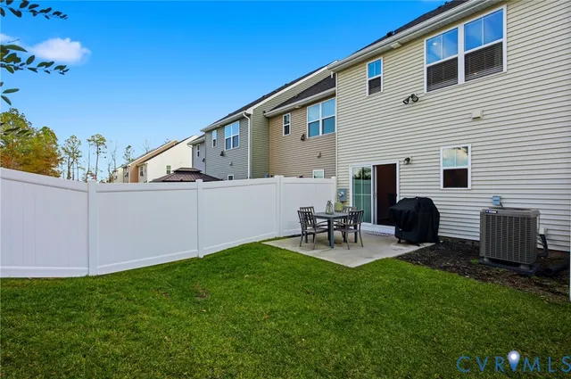 a view of backyard with two chairs and a table