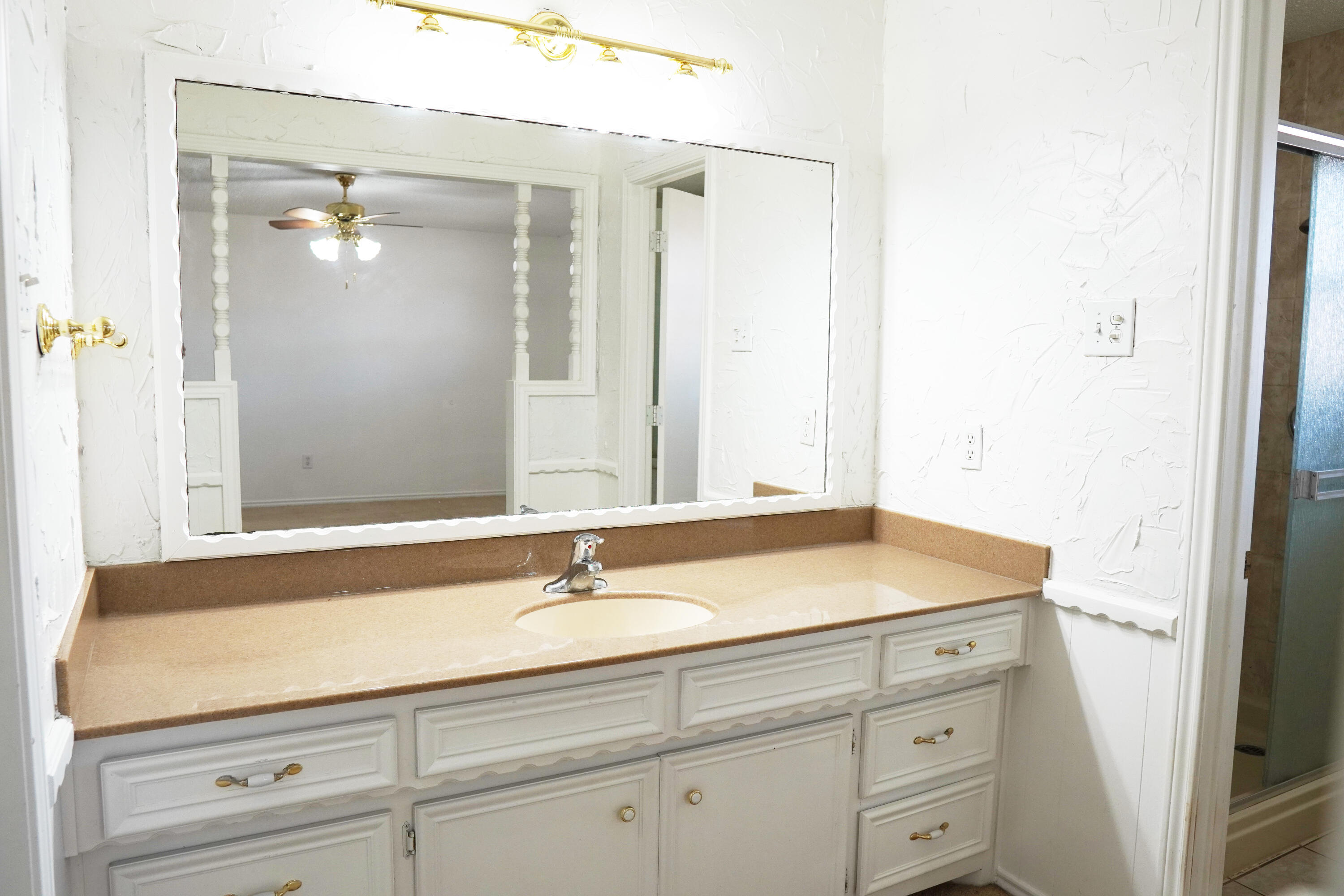 5520 80th Street Lubbock, TX 79424 - Photo 18 of 29 a bathroom with a sink and a mirror