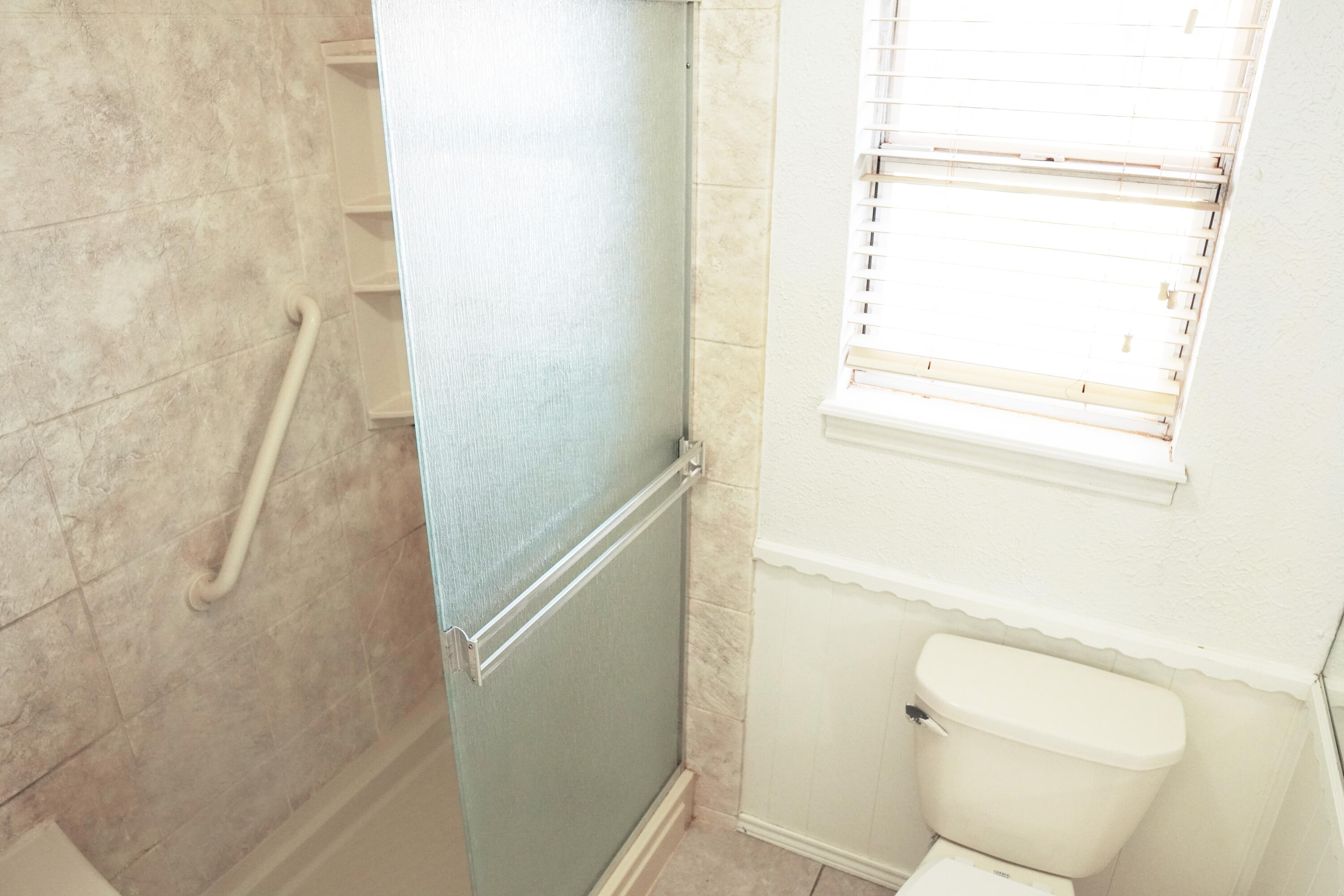 5520 80th Street Lubbock, TX 79424 - Photo 19 of 29 a bathroom with a toilet and a shower