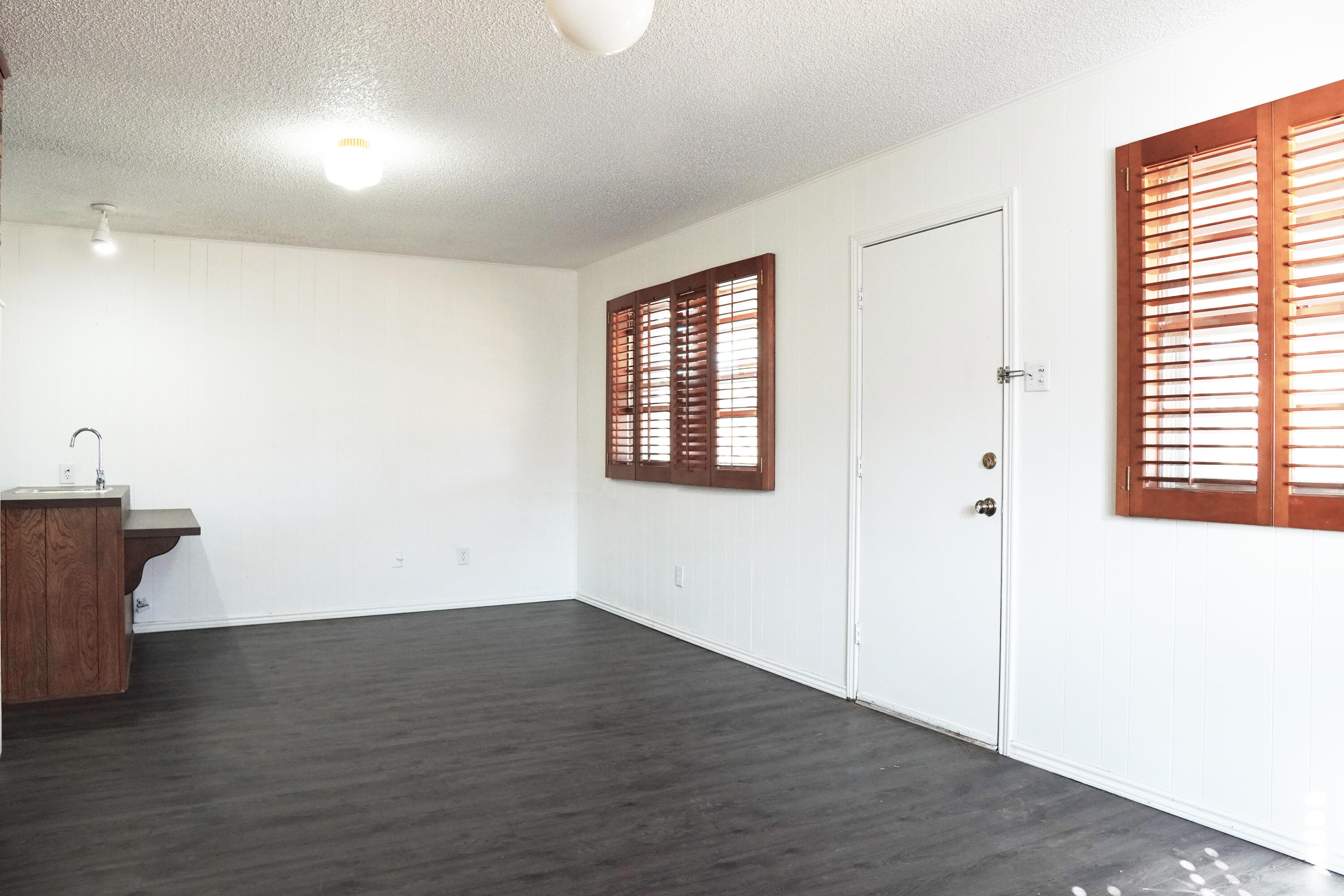 5520 80th Street Lubbock, TX 79424 - Photo 21 of 29 an empty room with wooden floor and windows