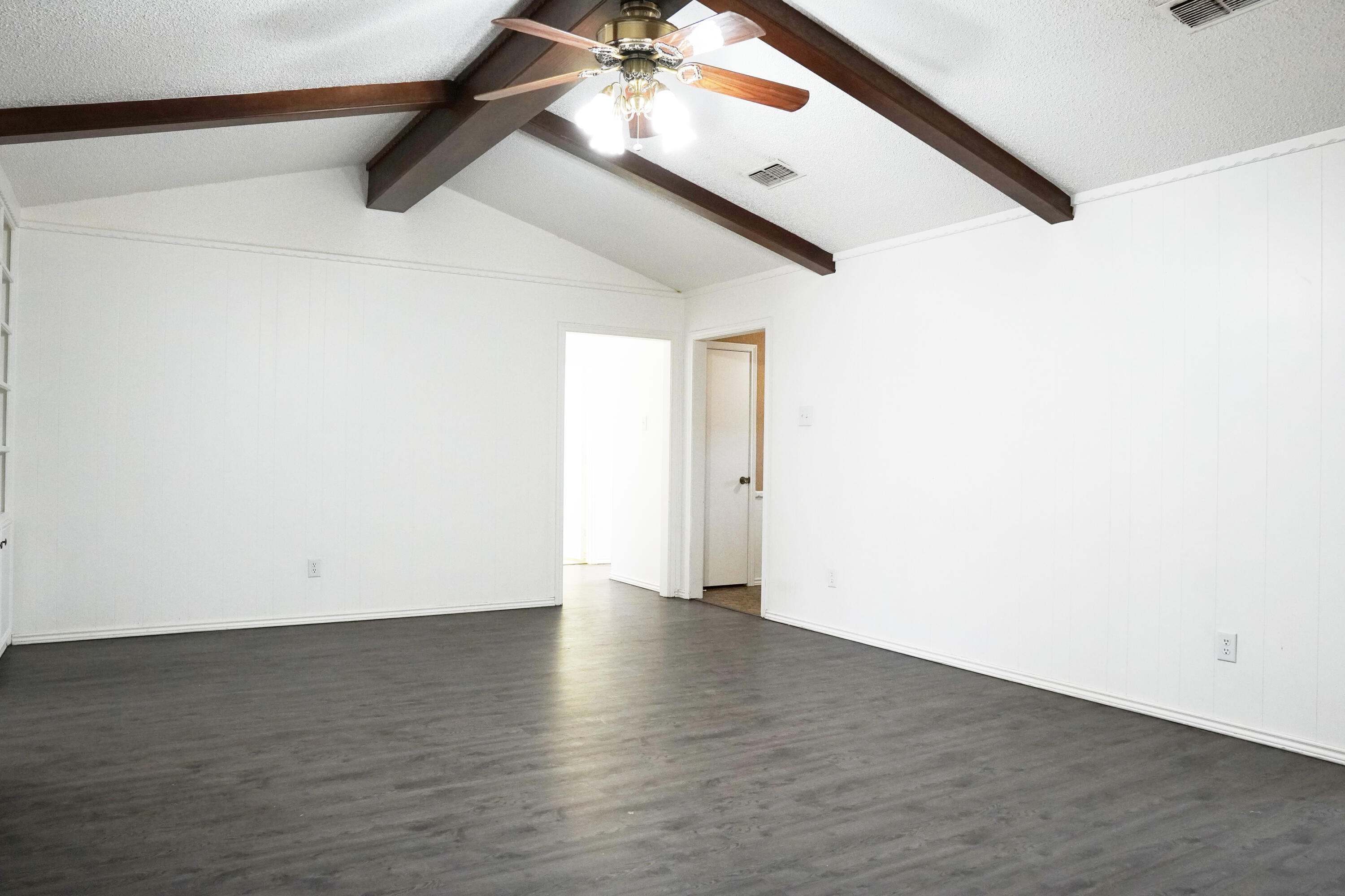 5520 80th Street Lubbock, TX 79424 - Photo 5 of 29 an empty room with wooden floor and windows
