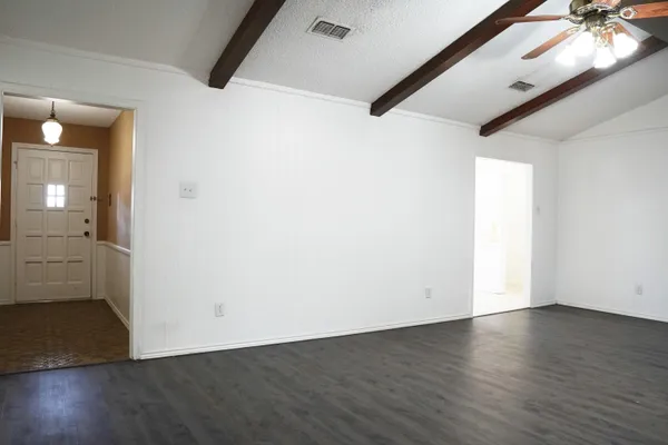 a kitchen with a refrigerator a stove top oven a sink and cabinets