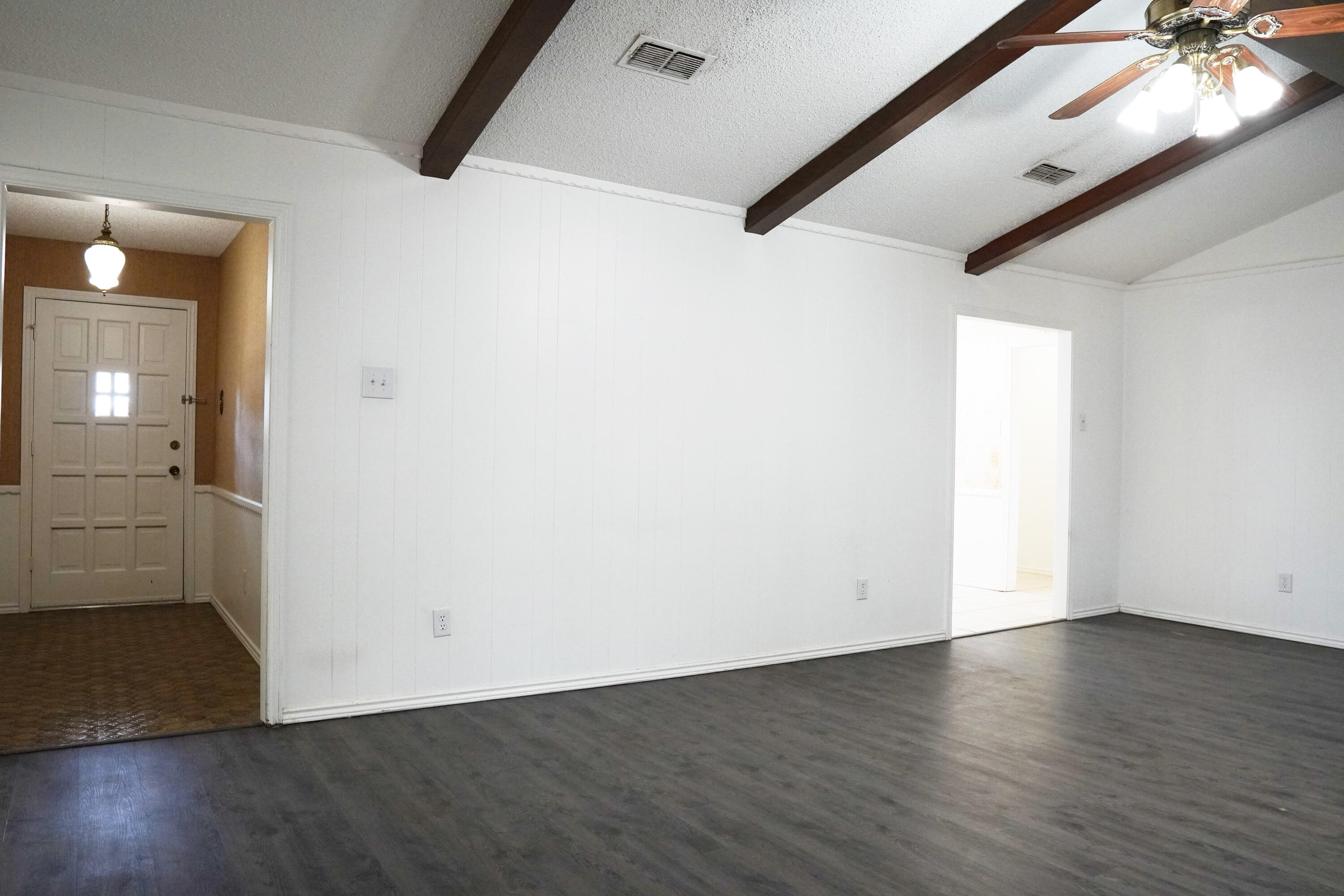 5520 80th Street Lubbock, TX 79424 - Photo 6 of 29 an empty room with wooden floor and windows