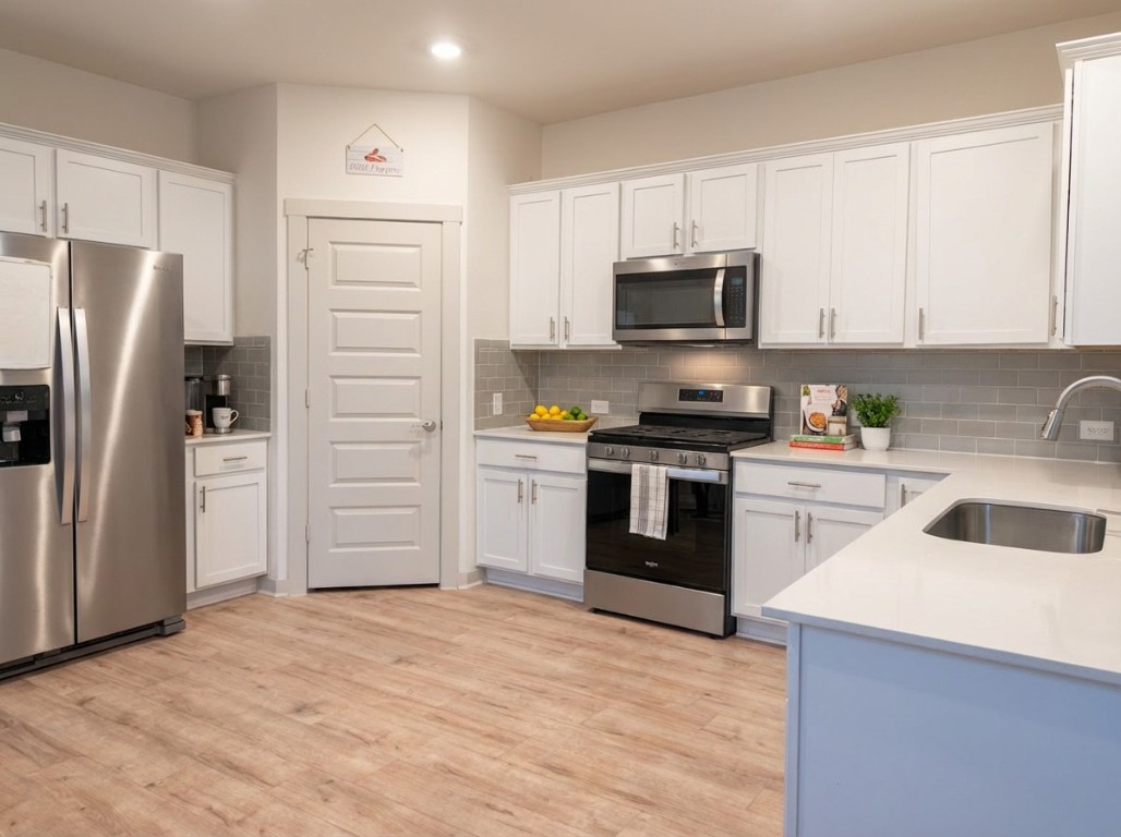 7515 Traylor Cove Austin, TX 78724 - Photo 3 of 13 a kitchen with granite countertop a refrigerator and a sink