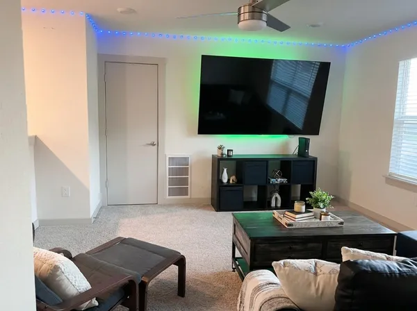 a bedroom with a bed and lamp next to a window