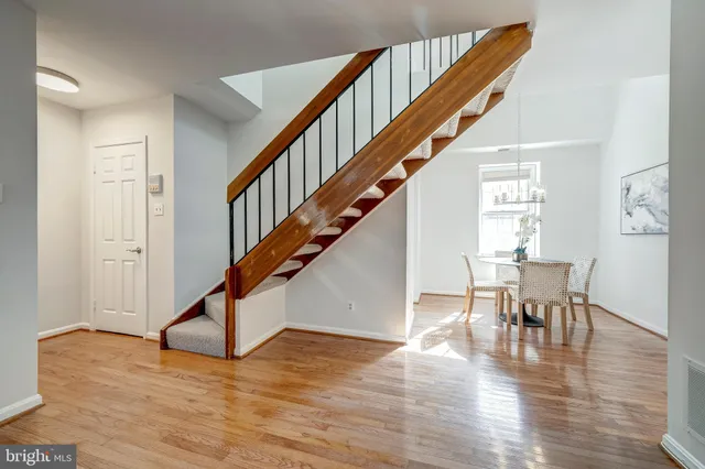 a view of entryway dining room and hall with wooden floor