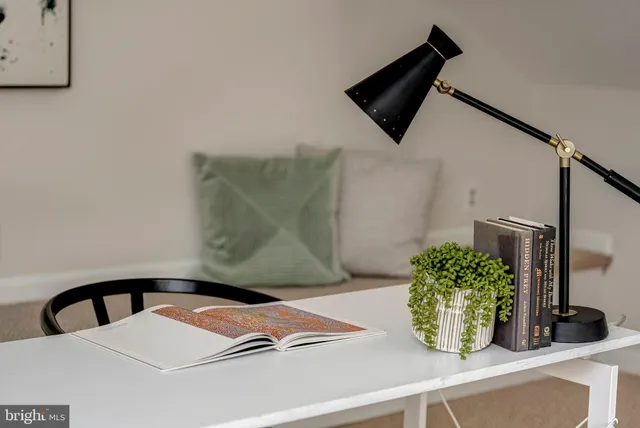 a bedroom with a bed and a potted plant