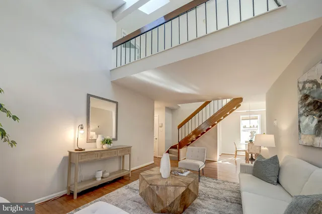 a living room with furniture and stairs