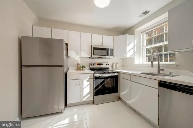 a kitchen with a refrigerator sink and microwave