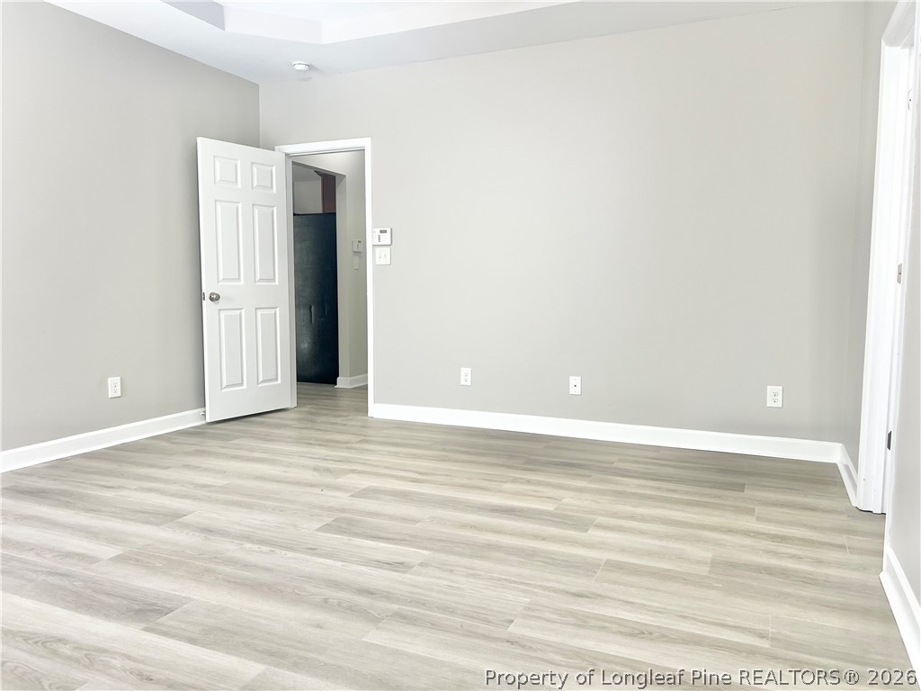 1523 Rough Rider Lane Parkton, NC 28371 - Photo 26 of 42 a view of an empty room with wooden floor