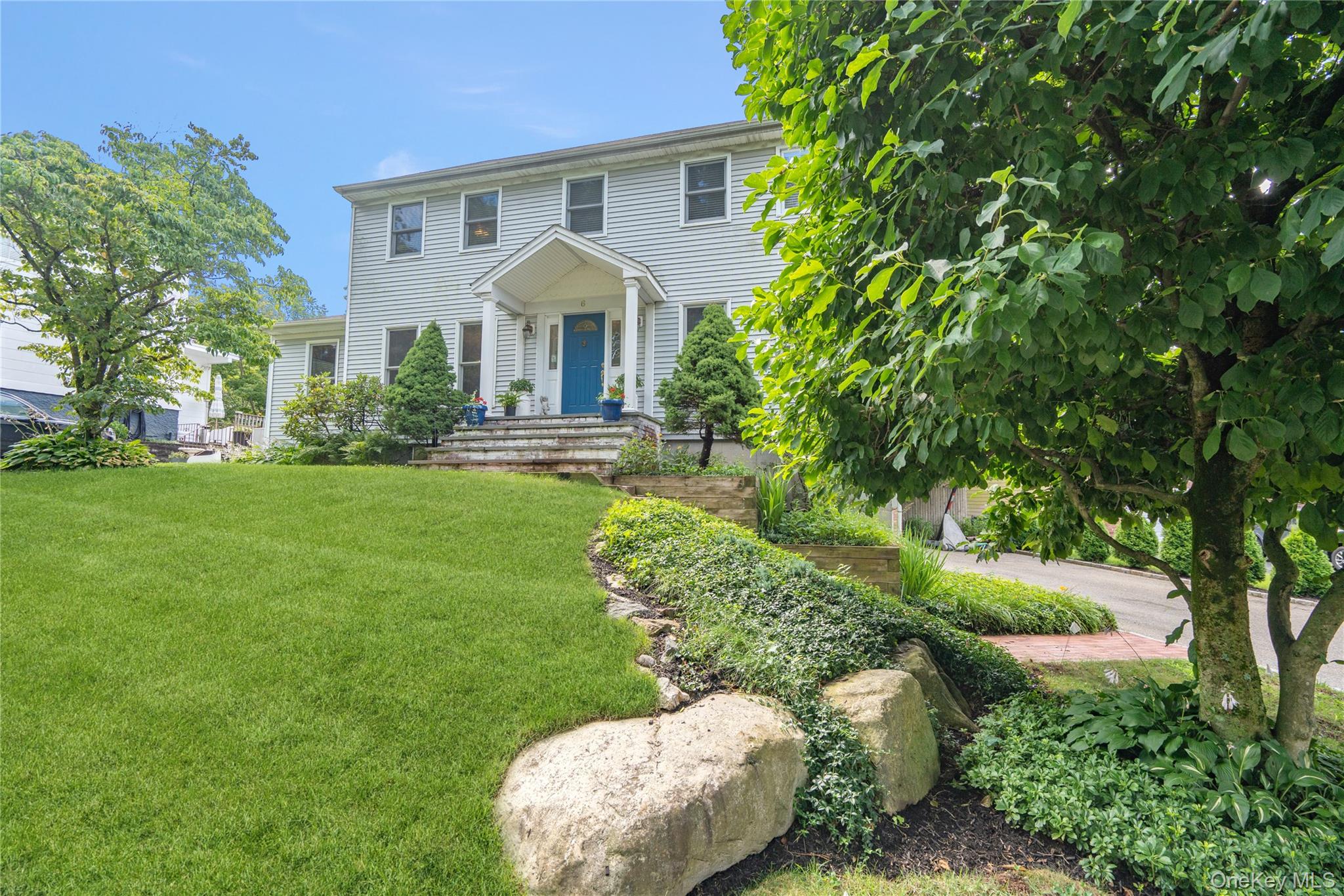 6 Cedar Avenue Locust Valley, NY 11560 - Photo 2 of 31 a front view of a house with a yard