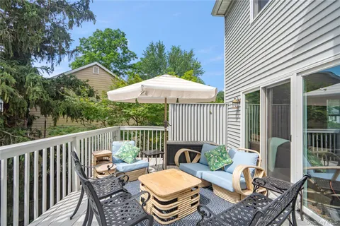a view of balcony with furniture and umbrella