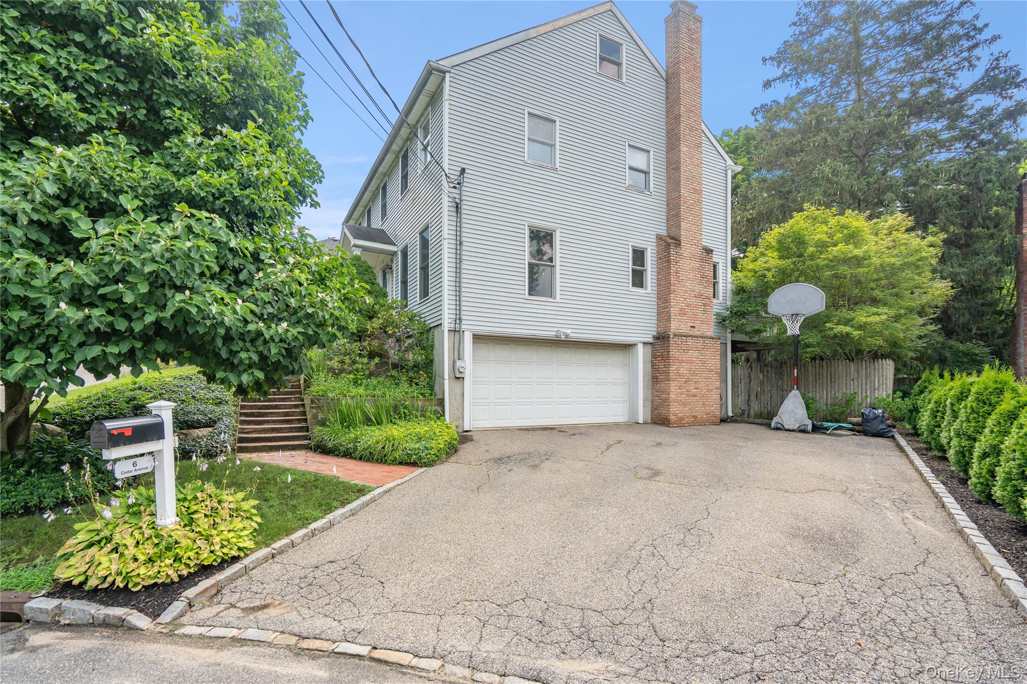 6 Cedar Avenue Locust Valley, NY 11560 - Photo 3 of 31 a front view of a house with garden