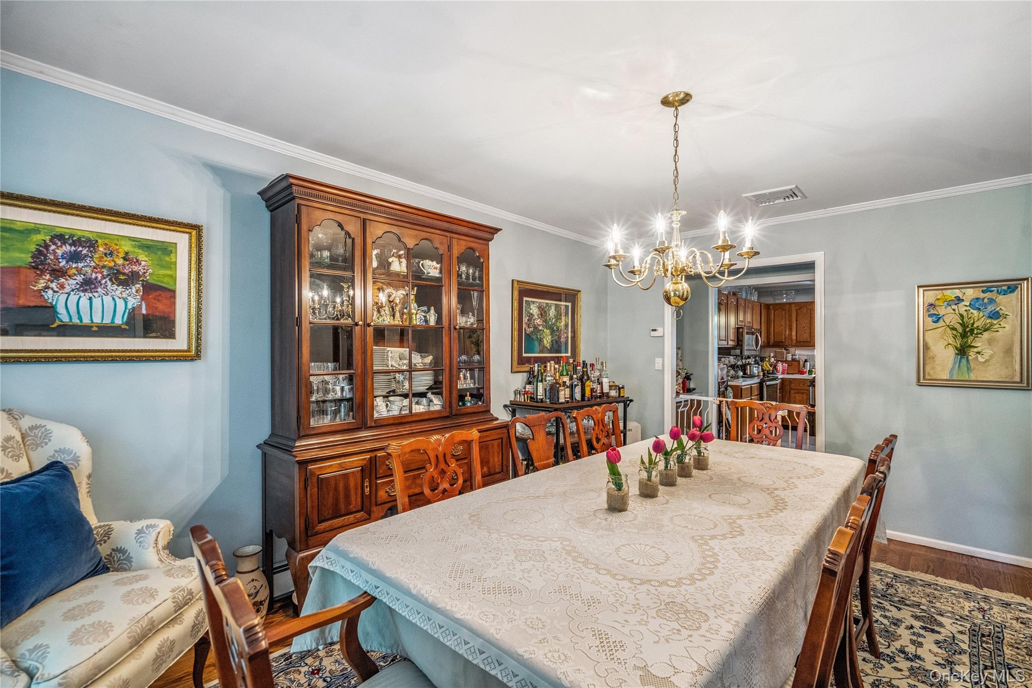 6 Cedar Avenue Locust Valley, NY 11560 - Photo 5 of 31 a view of a dining room with furniture a chandelier and wooden floor