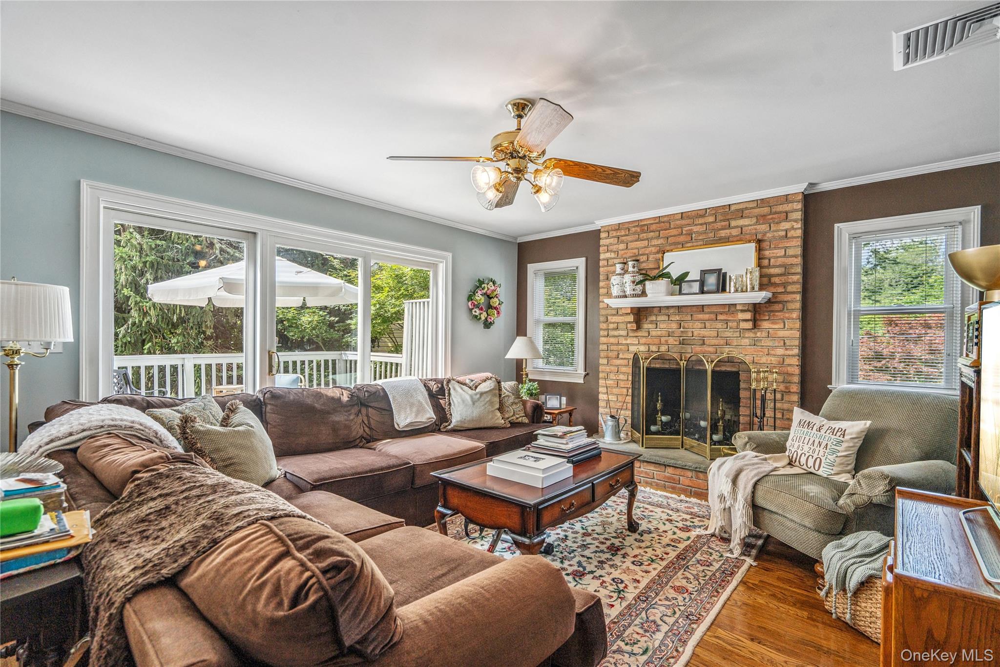 6 Cedar Avenue Locust Valley, NY 11560 - Photo 6 of 31 a living room with furniture a fireplace and a large window