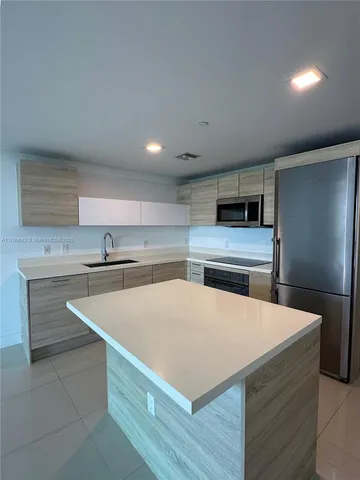 a view of a room with furniture and wooden floor