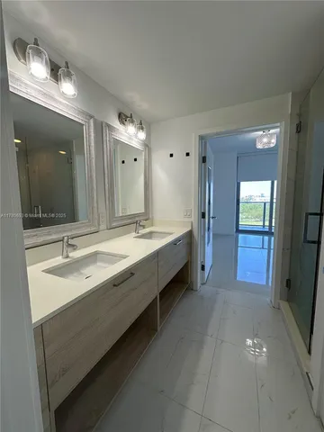 a bathroom with a double vanity sink and a mirror