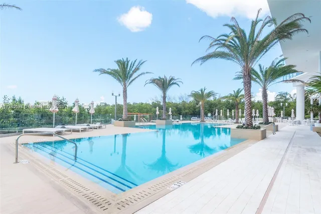 a living room with furniture and floor to ceiling windows