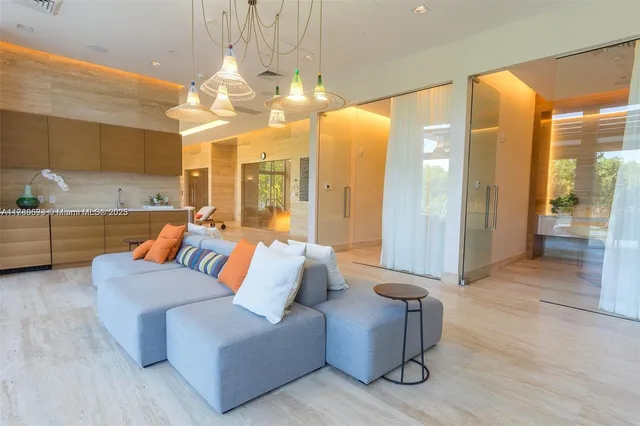 a living room with furniture and large windows